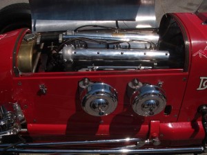 The engine compartment looks as clean as the vintage race car looks on the outside.