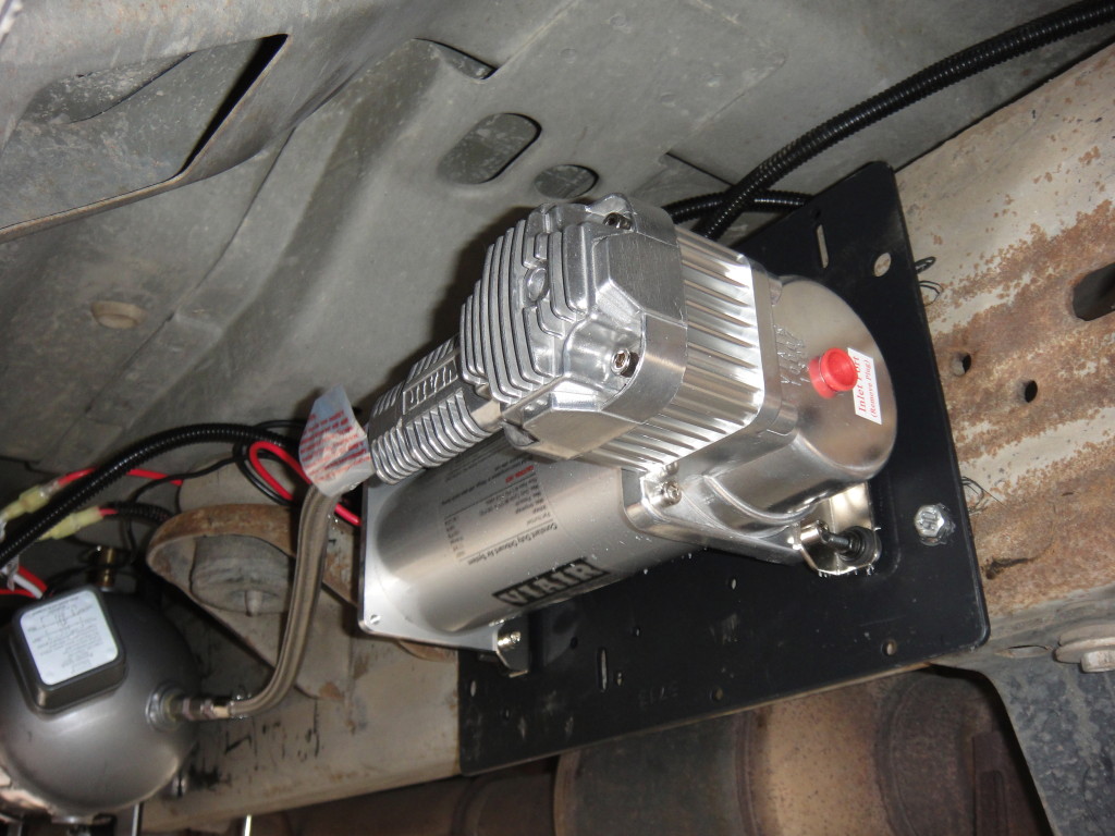 Air compressor mounted to frame