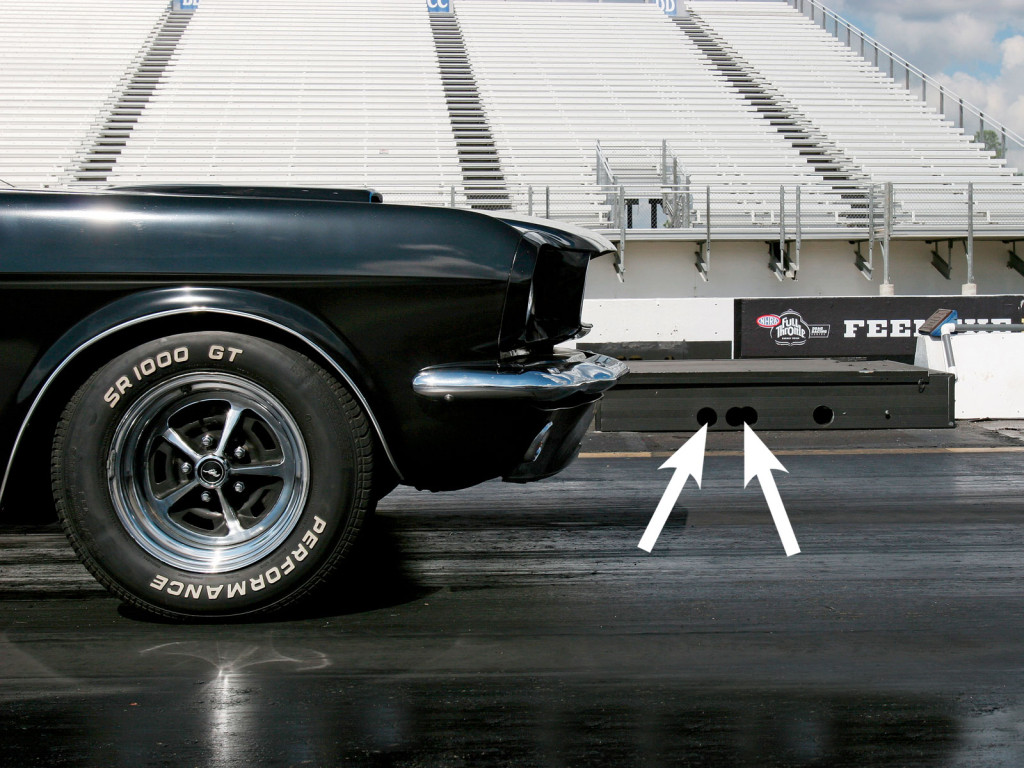 When staging your car, you will first “break” the Pre-Stage beam (first arrow), and then the Stage beam (second arrow). You cannot see the beam cross the track, but it is emitted from the holes in the box on the ground at the starting line.