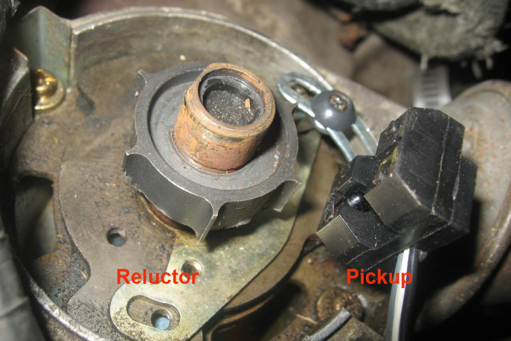 A close-up look at the inside of an electronic ignition distributor. As the reluctor passes the pickup, the primary ignition circuit opens, firing the coil.