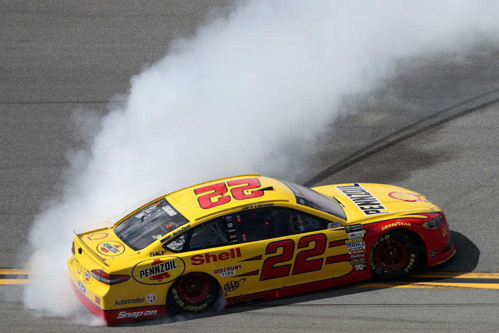 Joey Logano celebrates with a burnout.  (Photo by Chris Graythen/Getty Images)