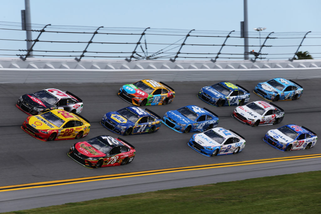 Martin Truex Jr. and Austin Dillon lead a pack of cars.  (Photo by Jerry Markland/Getty Images)