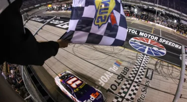 Credit: BRISTOL, TENNESSEE - SEPTEMBER 16: Denny Hamlin, driver of the #11 FedEx Freight Direct Toyota, takes the checkered flag to win the NASCAR Cup Series Bass Pro Shops Night Race at Bristol Motor Speedway on September 16, 2023 in Bristol, Tennessee. (Photo by Meg Oliphant/Getty Images)