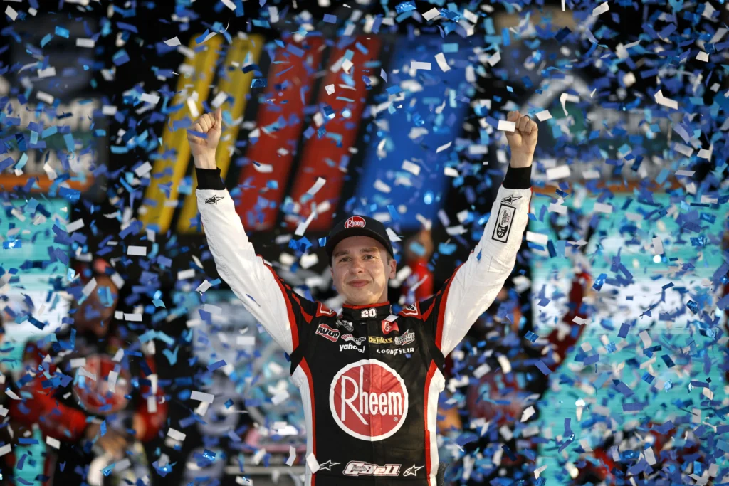 HOMESTEAD, FLORIDA - OCTOBER 22: Christopher Bell, driver of the #20 Rheem/Watts Toyota, celebrates in victory lane after winning the NASCAR Cup Series 4EVER 400 Presented by Mobil 1 at Homestead-Miami Speedway on October 22, 2023 in Homestead, Florida. (Photo by James Gilbert/Getty Images)